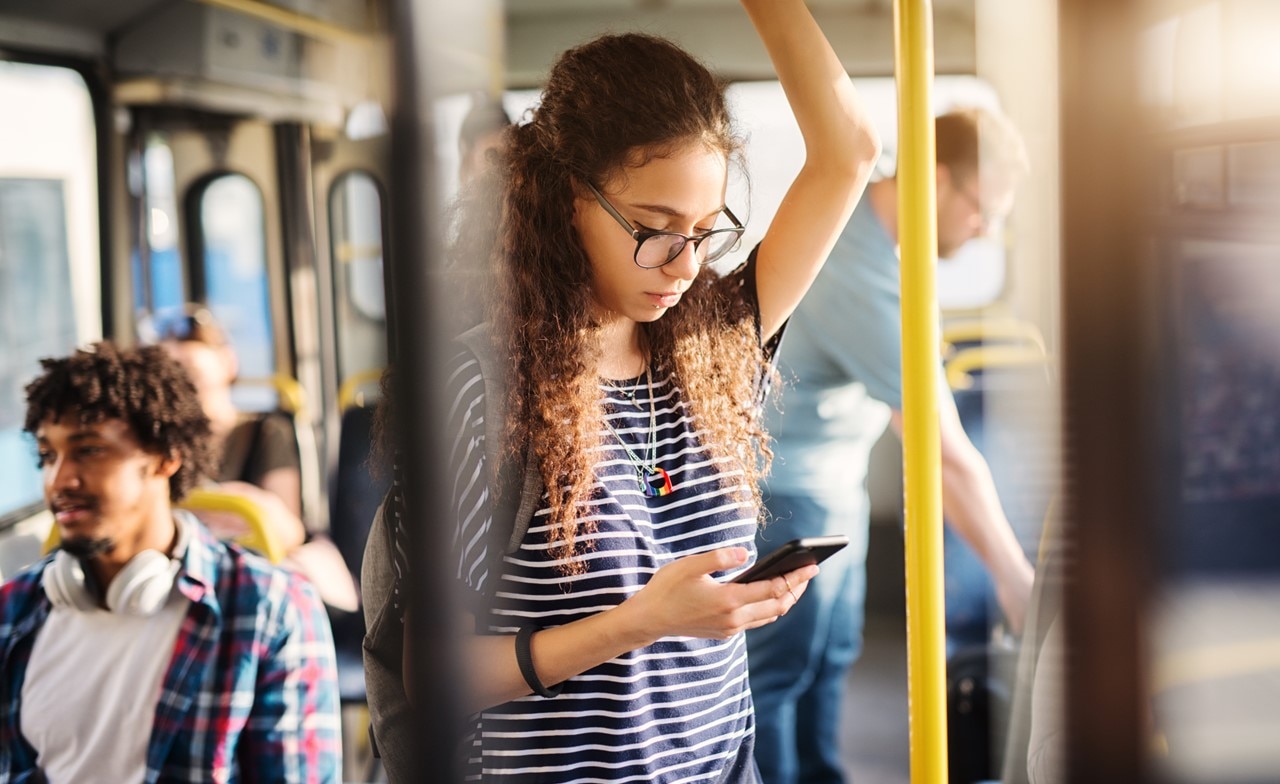 Girl looking at her phone in public transport