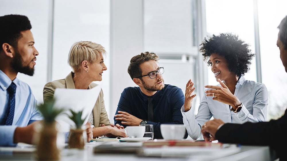 Businesspeople sitting together in a meeting Businesspeople sitting together in a meeting