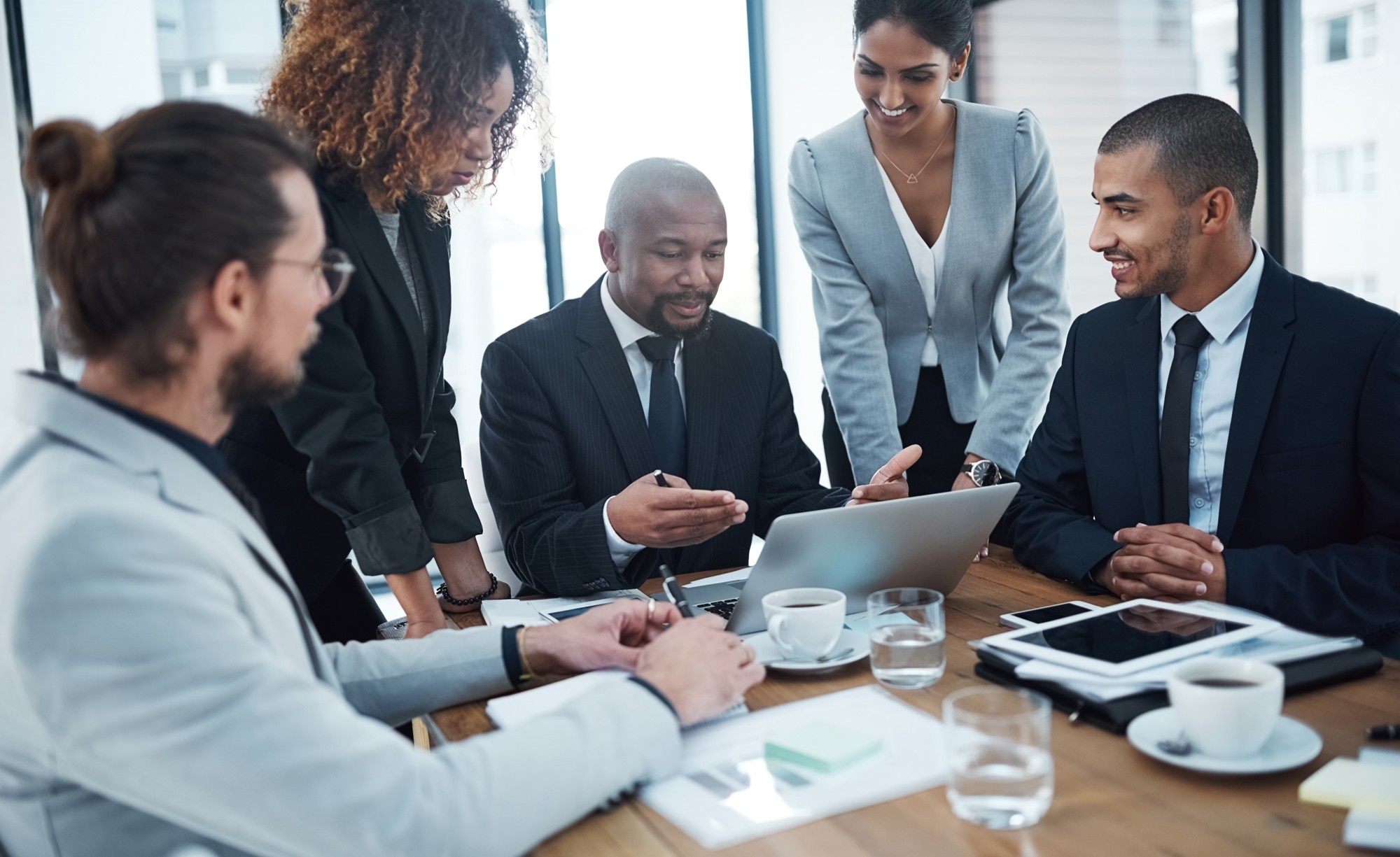 Consultants meeting around table and laptop