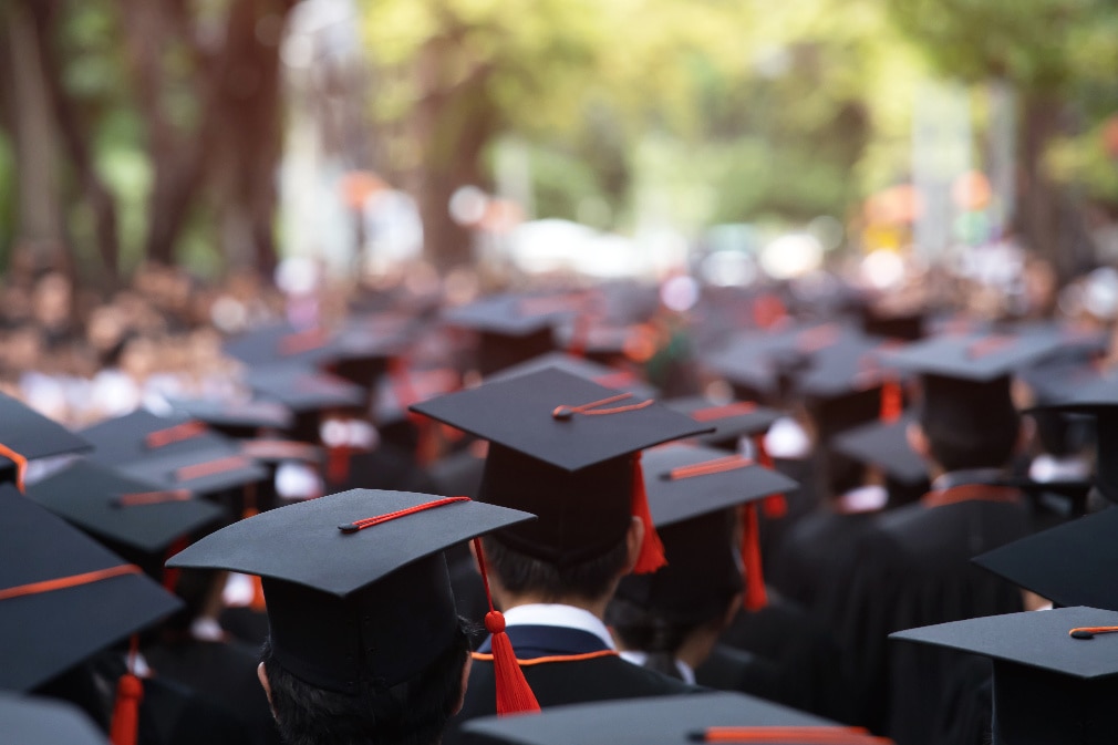 University students graduating in cap and gown