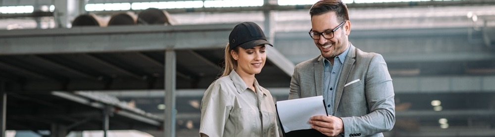 Manager and employee talking at manufacturing factory