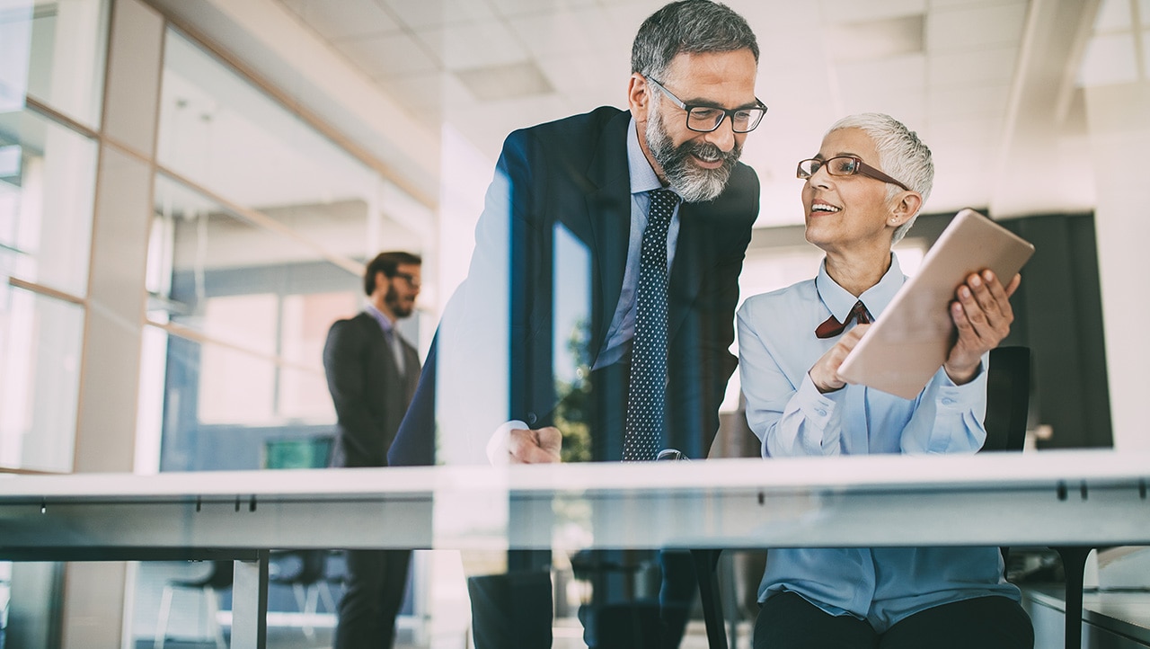 Man and women working on a computer