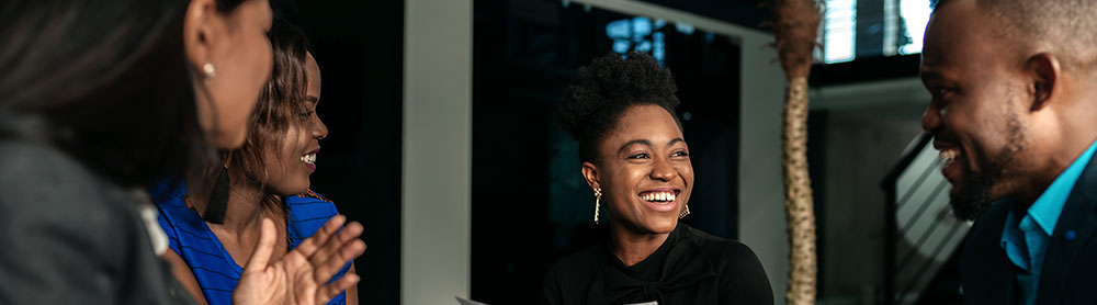 Meeting image central gov People in a meeting and laughing