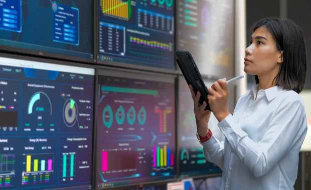 Woman looking at the stats on wide screen