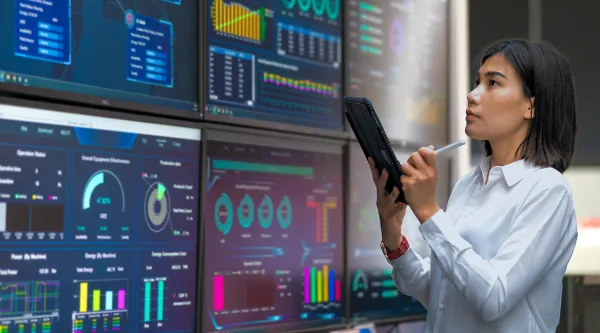 Woman looking at the stats on wide screen