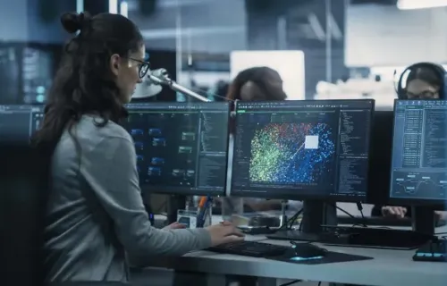 woman looking at data on computer