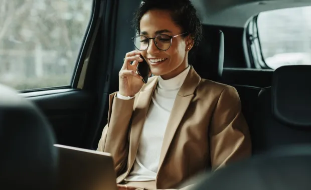 Business executive on a phone in a car