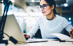 Business woman reading laptop