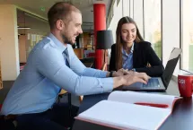 CGI partners looking at laptop together