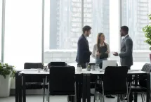 colleagues standing around a table