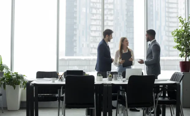 colleagues standing around a table