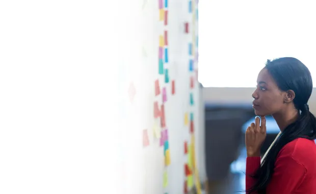 Woman looking at the stick notes