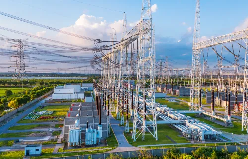 Electrical substation with towers, transformers, and power lines