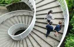 consultants walking in spiral staircase