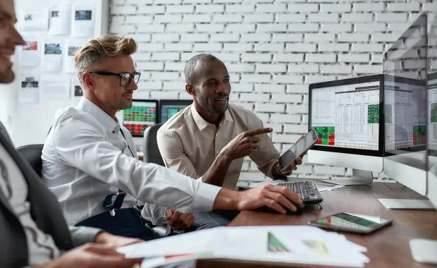 Employees looking at screen together