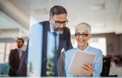 consultant and banking client looking at tablet