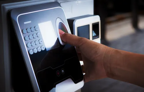 close up of a person using finger scan on bank ATM