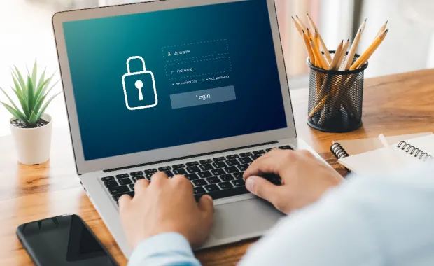 A person types on a laptop displaying a secure login screen, reflecting efforts to strengthen digital defenses and ransomware resiliency