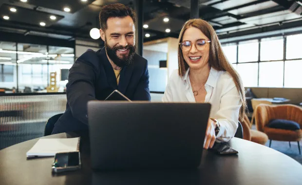 Two professionals looking at laptop