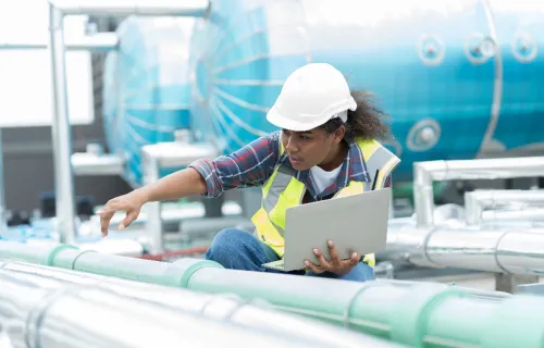 woman with laptop at oil and gas industry