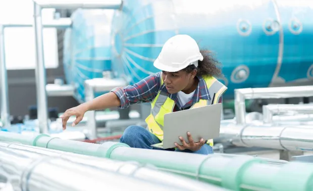 woman with laptop at oil and gas industry
